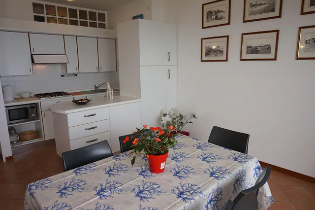 Angolo cottura con tavolo apparecchiato e fiori
