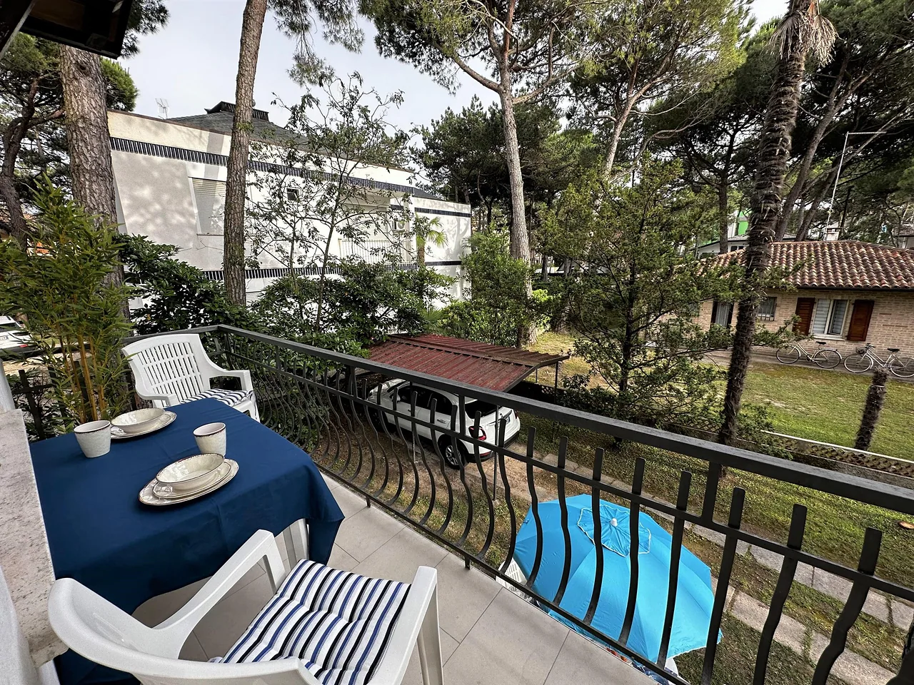 Terrazzo affacciato sul giardino alberato con tavolo per la colazione
